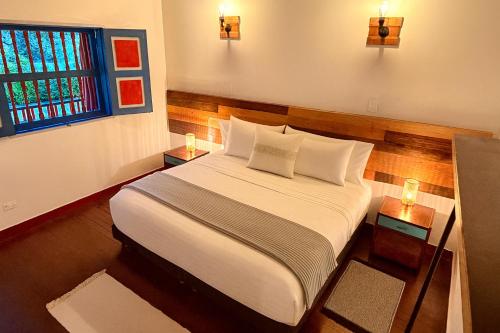 Postel nebo postele na pokoji v ubytování Dreamer Cocora