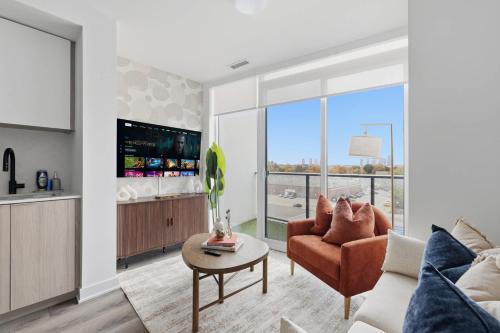 a living room with a couch and a table at Modern West Getaway 2BR Condo with Free Parking in Toronto