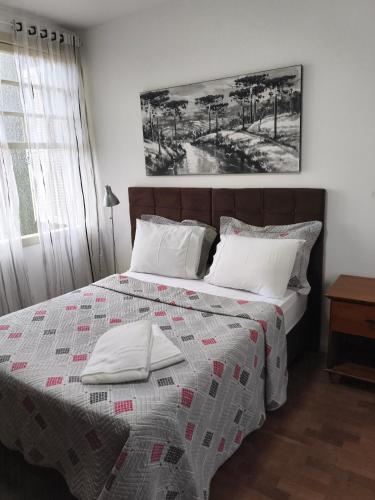 a bedroom with a bed with a quilt on it at Cantinho do Sossego in Campo Alegre