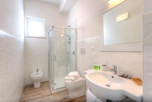 a bathroom with a sink and a toilet and a shower at Conero Infinito in Numana
