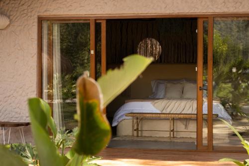 Ένα ή περισσότερα κρεβάτια σε δωμάτιο στο Holistic EcoHotel