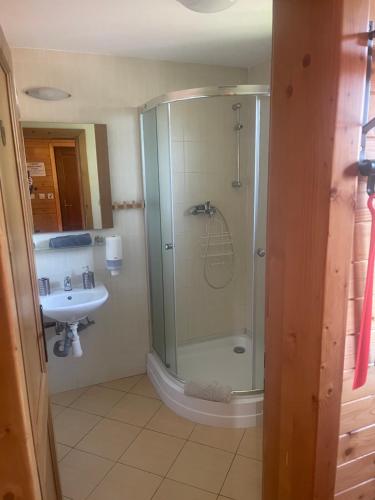 a bathroom with a shower and a sink at Liptovské Drevenice-chaty in Liptovský Mikuláš