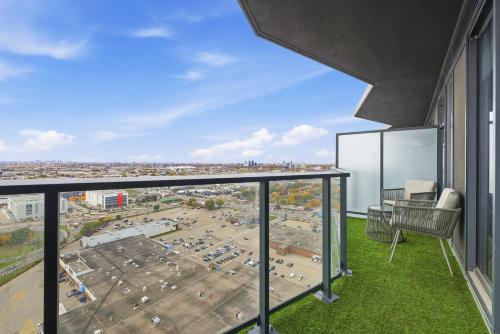 an apartment balcony with a view of a parking lot at Skyline Studio with Stunning City Views & Parking in Toronto