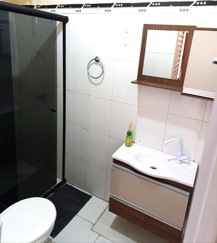a bathroom with a shower and a sink and a toilet at Pe no Centro in Porto Seguro