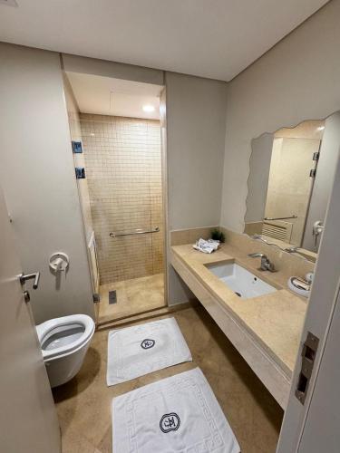 a bathroom with a toilet and a shower and a sink at Mangrove M1-5B-13 in Hurghada