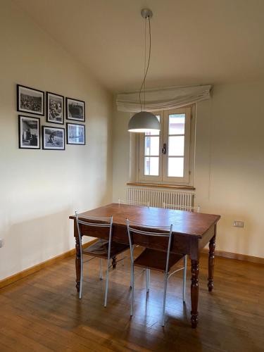 a dining room with a wooden table and chairs at Landi House in Uzzano
