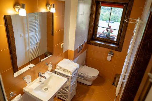 利托斯基简Zrub Raj的浴室里有洗手池、马桶和镜子。