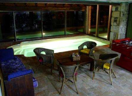 a room with chairs and tables and a large window at Can Ventura in Sant Felíu de Pallarols