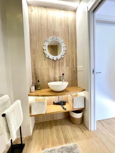a bathroom with a sink and a mirror at Brisa do Mar in Finisterre