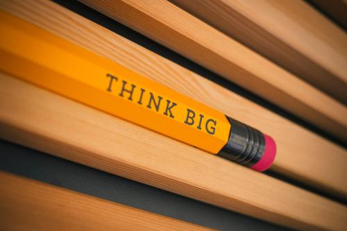 a think big sign on the side of a yellow pencil at Vienna House Easy by Wyndham Limburg in Limburg an der Lahn