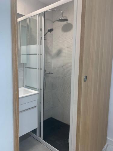 a bathroom with a glass shower and a sink at Othono &Theonos Walled City Studio in Nicosia