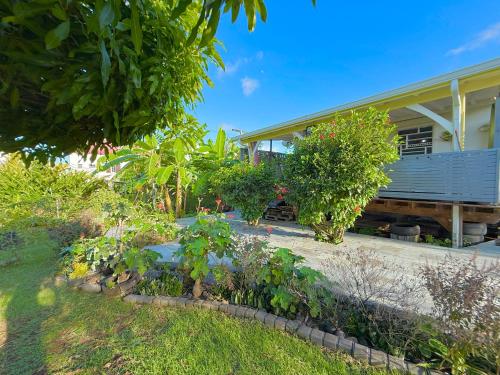 a garden in front of a house at Kanel' Kaz - Jacuzzi & Vue mer in Capesterre-Belle-Eau
