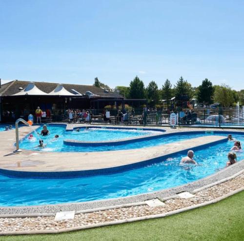 a group of people swimming in a pool at Marton Mere 8 Berth Caravan in Blackpool
