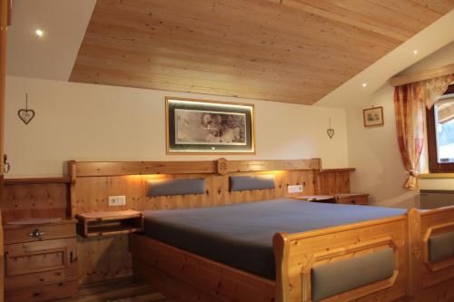 a bedroom with a large wooden bed in a room at Haus Kraft in Sankt Martin am Tennengebirge