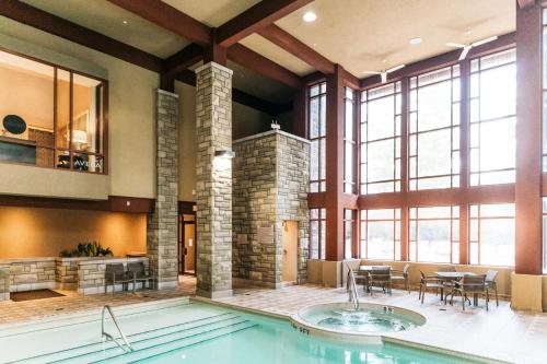 a large indoor pool with a table and chairs at DoubleTree Fallsview Resort & Spa by Hilton - Niagara Falls in Niagara Falls