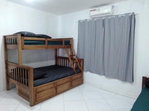 a bunk bed in a room with a window at Pink house Enseada Beach in Guarujá