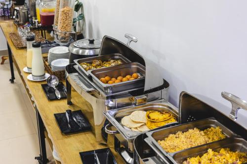 um buffet com muitos tipos diferentes de comida em Hotel Suite Comfort em Medellín