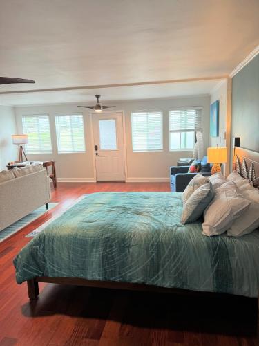 a bedroom with a large bed and a living room at Spacious Studio Near Beaches & Dining in Waikoloa Village