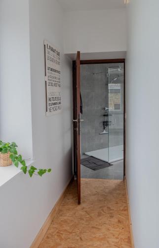 a glass door in a room with a white wall at Sur la Colline in Houffalize