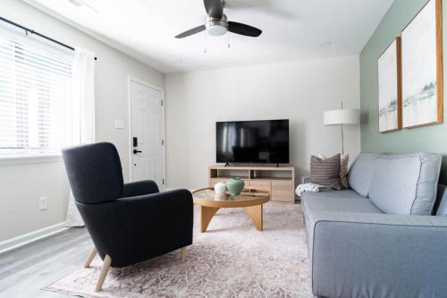 a living room with a couch and a tv at The Vibe on Durham XI 8788 in Durham