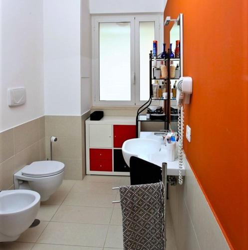a bathroom with a white toilet and a sink at Sporting Club Resort in Praia a Mare