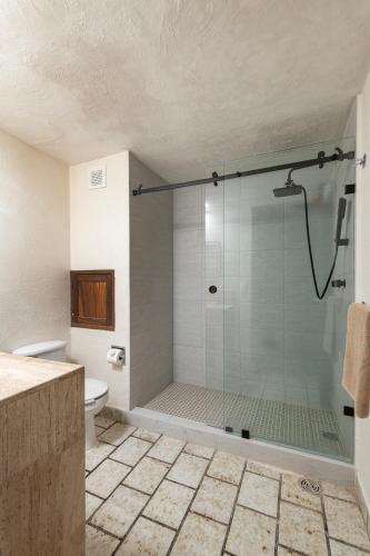 a bathroom with a glass shower with a toilet at 2BR Oceanside Resort Condo Pool & Private Beach in Puerto Vallarta