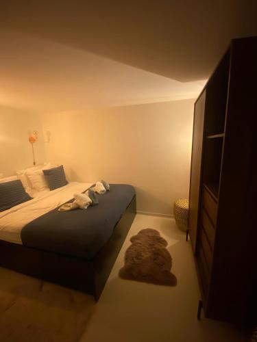 a bedroom with a bed and a dresser at Houseboat Ark van Amstel in Amsterdam