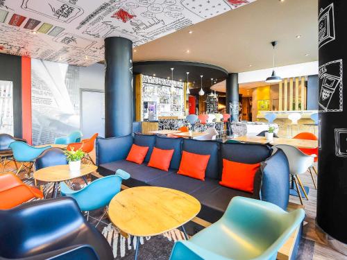 a restaurant with blue and orange chairs and tables at Ibis budget Dijon Centre Clemenceau in Dijon