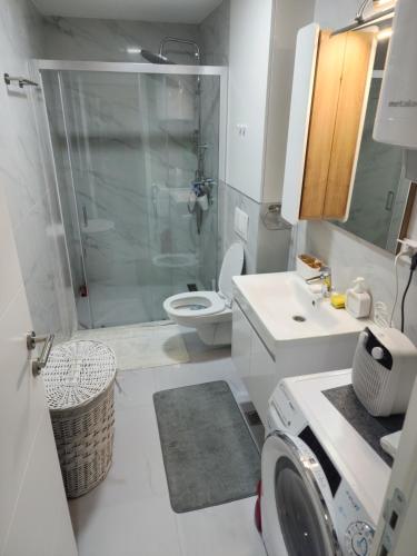 a bathroom with a shower and a toilet and a sink at Apartman Smaragd in Loznica