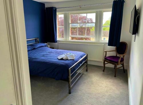 Un dormitorio con una cama, una silla y una ventana en Brandon House, en Brandon