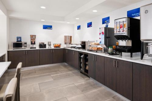 a large kitchen with brown cabinets and appliances at Best Western El Paso Airport Entrada Hotel in El Paso