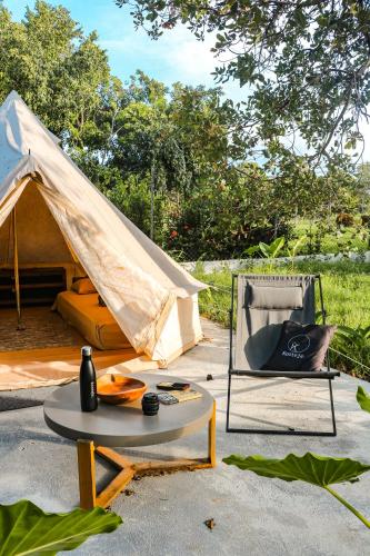 a tent and a chair and a table in front of a table at Kooteja Aurora Coronado Nature Villa with Private Pool & Glamping Experience in Las Lajas