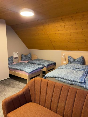 a room with two beds and a couch in it at Apartmány U Dvořáků in Janske Lazne