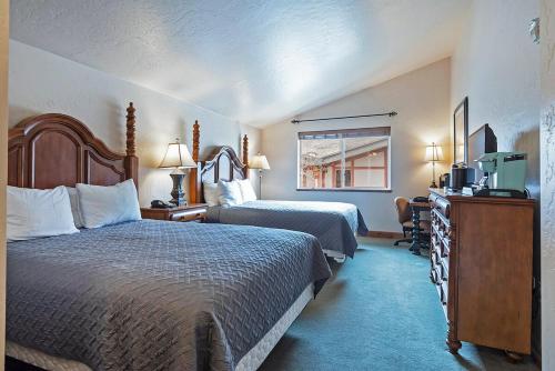 a hotel room with two beds and a television at Zermatt Double Queen Suite Near Park City - 3074 in Mound City