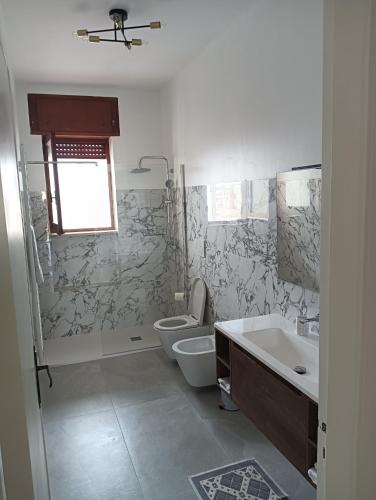 a bathroom with a toilet and a sink at Dimora De' Luna in Lecce