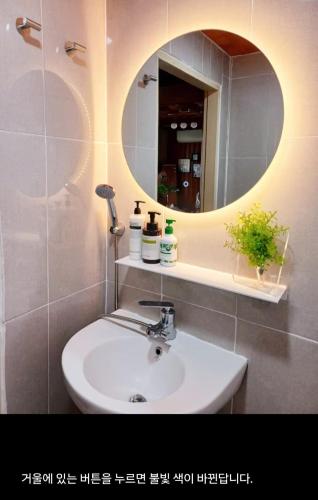 a bathroom with a sink and a mirror at Urban in Suwon