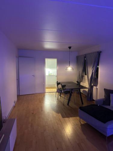 a living room with a table and a couch at Lejlighed in Måløv