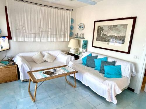 a living room with a couch and a table at Amazing view apartment in Porto Rotondo