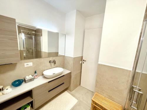 a bathroom with a sink and a shower at Amazing view apartment in Porto Rotondo