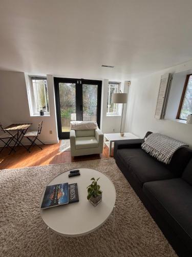a living room with a couch and a table at Bright Garden Suite Across From Park in Kitsilano in Vancouver