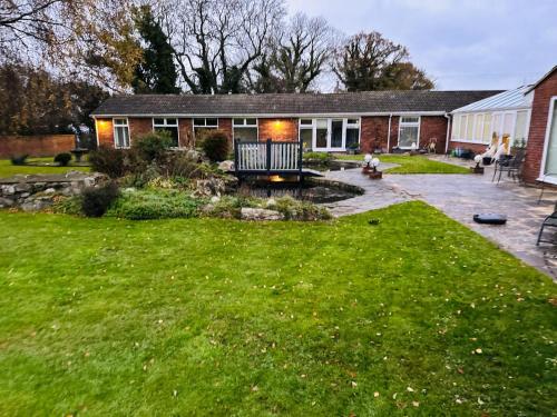 a backyard of a house with a lawn and a house at Randall Farm in Fawkham