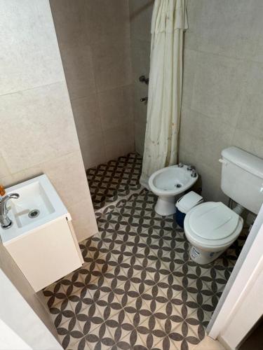 a bathroom with a toilet and a sink at Esmeralda in San Benito