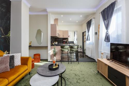 a living room with a couch and a table at Old Town Treasure Apartments in Debrecen