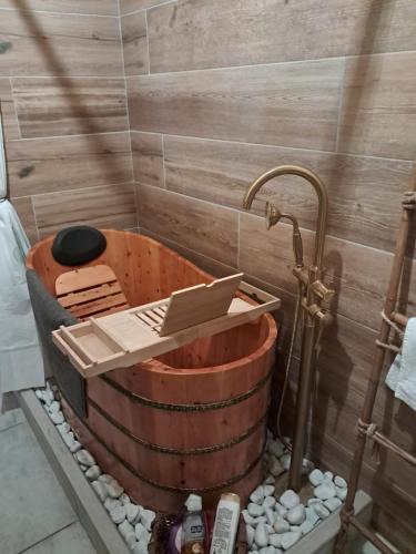 a bath tub with a faucet in a shower at Sakura B&B Franciacorta in Cologne