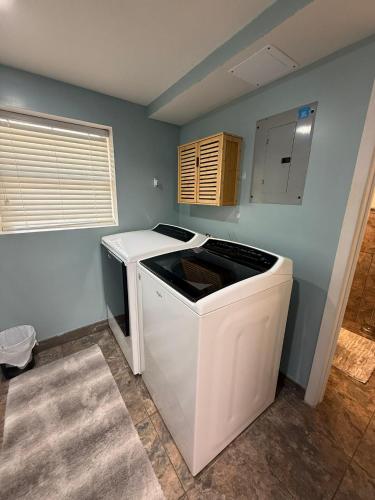 a washer and dryer in a corner of a room at Landing on Lake Time: Lakefront-4BD/2BA/Private Dock/Decks/Firepit-10PP in Gravois Mills