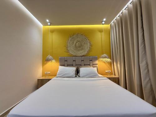 a bedroom with a large bed with a yellow headboard at Vue imprenable sur mer in Tangier