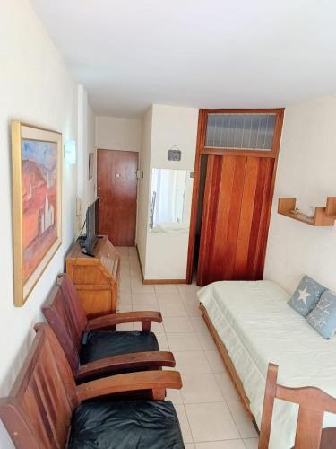 una camera d'albergo con due letti e una televisione di Depto Avenida Colón-Mar del Plata a Mar del Plata