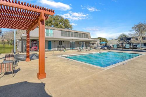 a swimming pool in front of a house at Townhouse A plus location pool long stay discounts in Sherman