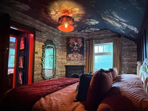 a bedroom with a bed and a brick wall at The Funky Hideaway with hot tub in Bangor