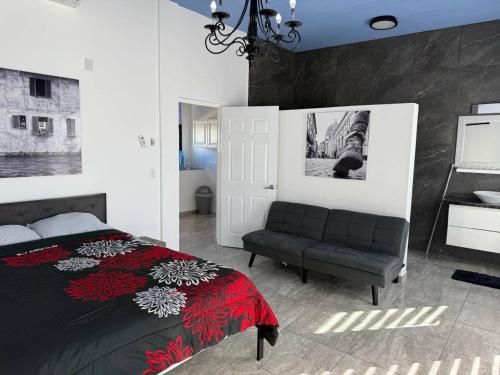 a bedroom with a bed and a couch at Ocean View Suite in Gated Community, Kino Bay MX in Bahía Kino